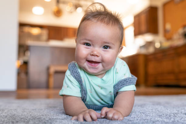 Baby laying on carpet floorings | Green's Floors & More